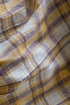 Close-up of checkered cotton linen fabric with yellow and purple pattern