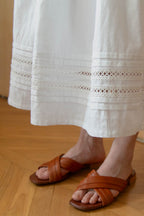 Close-up of tiered pintucks and lace trim on deadstock cotton skirt