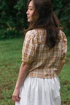 Contrast binding detail along neckline and cuffs, cotton-linen blouse. Back view