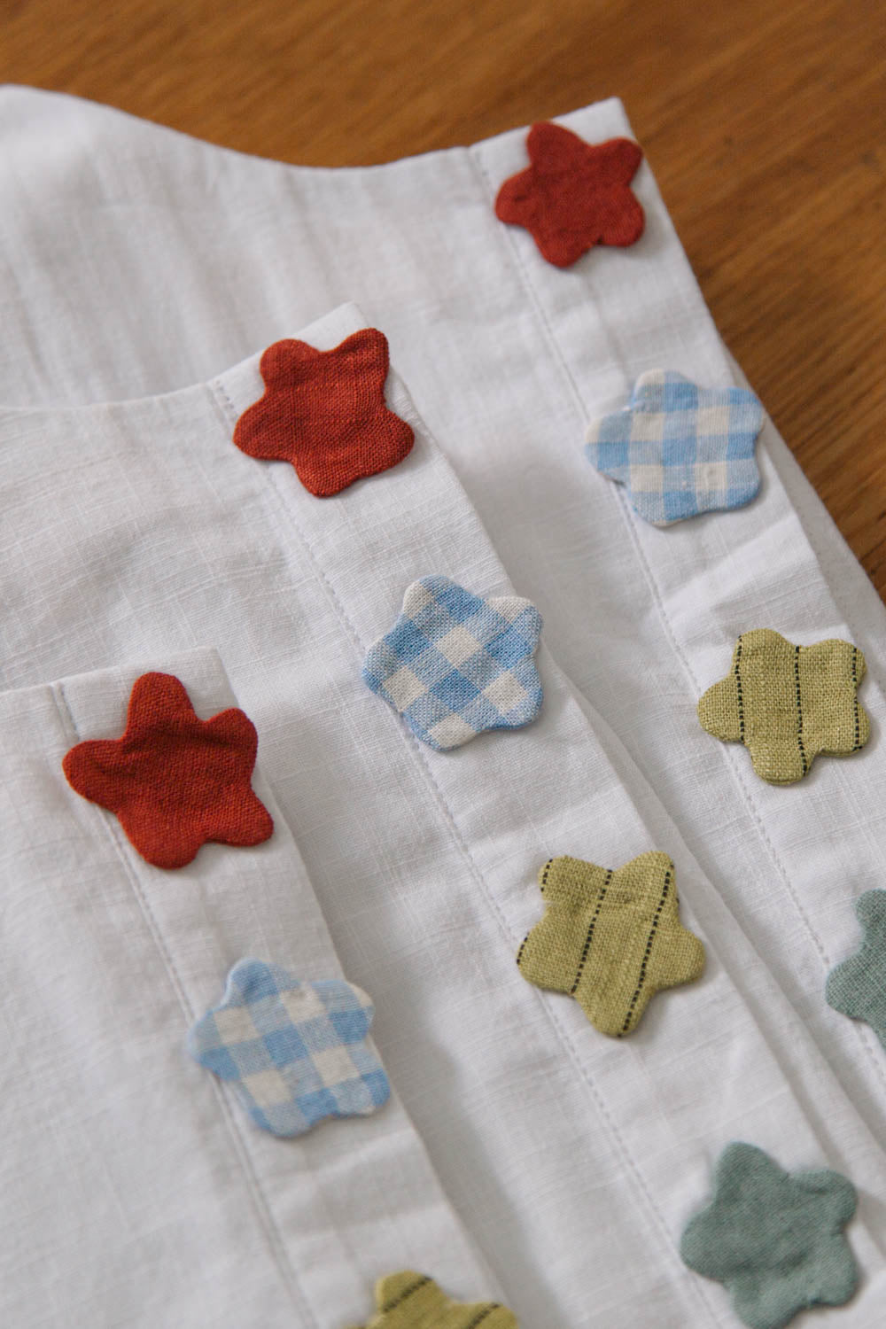 Close-up of floral appliqués on deadstock cotton sleeveless top
